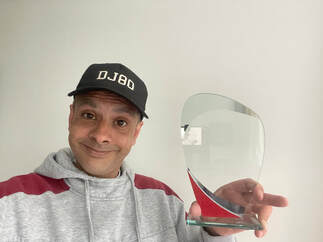 Picture of DJ80 holding an award from ProMobile Magazine